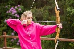 a young woman practicing at an archery range